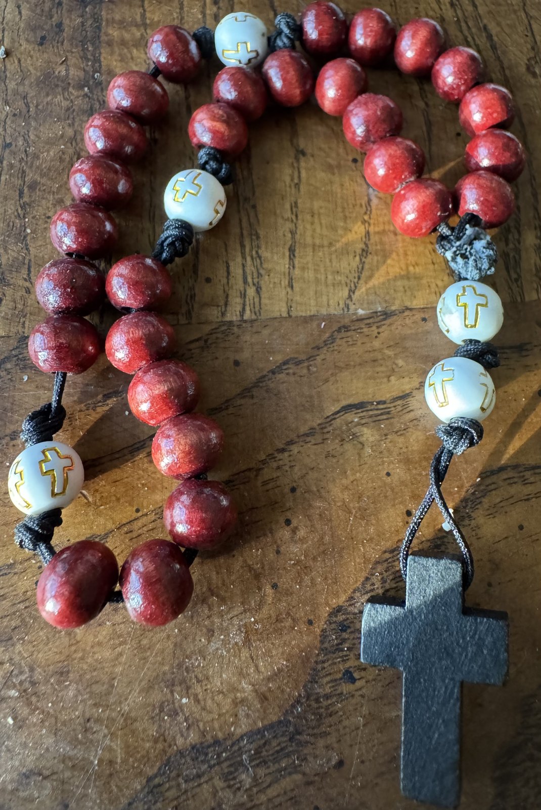 Red and white handmade Anglican rosary with black wooden cross